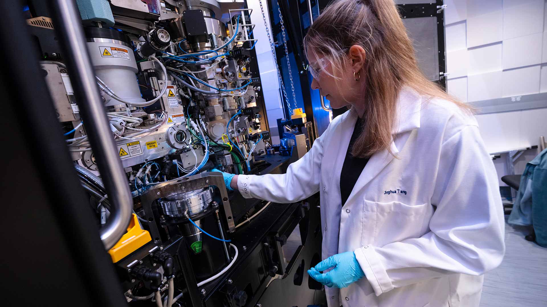 Researcher interacting with equipment in laboratory