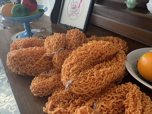 curly orange yarn. the remains of like a waffle cardigan
