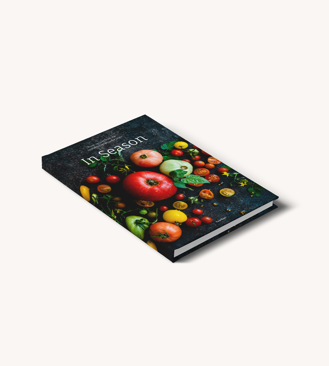 A cookbook titled In Season with apples on the cover.