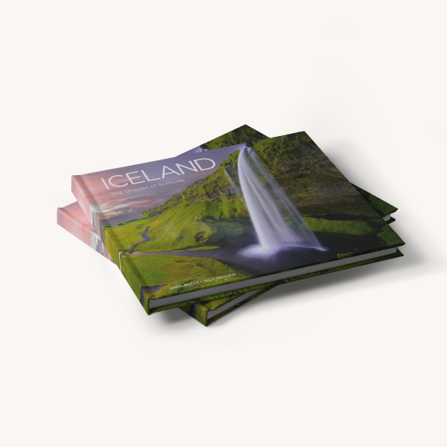 A travel photo book with scenic images of Iceland.