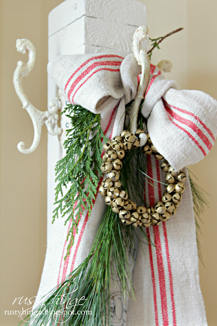 Rusty Hinge 2015 Rustic Meets Refined Christmas Home Tour Vintage porch post coat stand with grainsack bow and sleigh bells