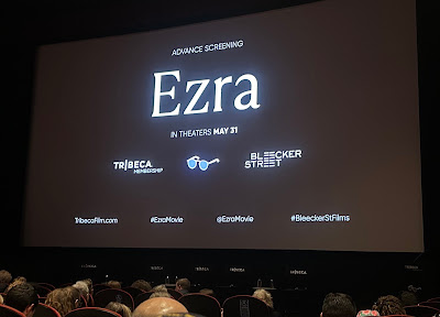 Promo screen for the movie Ezra, with white text on a black screen, as seen above the seated crowd in the SVA movie theater. Promo screen for the movie Ezra, with white text on a black screen, as seen above the seated crowd in the SVA movie theater.