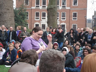 Me performing. Because the audience were sitting in a circle (the horseshoe shape had closed to become circular by the time I went on) the photographer got in shot the people on the opposite side of the circle to her.