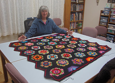 Robin Atkins with nearly completed crocheted afghan, Frida's Flowers Robin Atkins with nearly completed crocheted afghan, Frida's Flowers