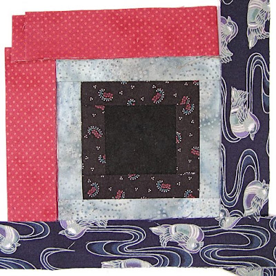 God's Eye quilt by Robin Atkins, auditioning fabrics, 2 choices