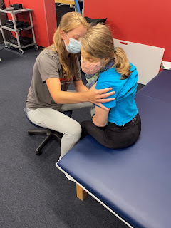 Ellie working on sitting at PT