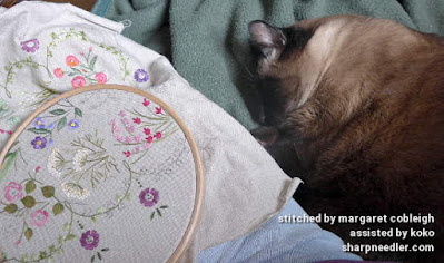 Siamese Assistance Koko the Siamese cat sleeps while Herbier is being embroidered