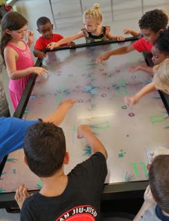 Clear Touch Interactive and NUITEQ Snowflake MultiTeach Picture of children interacting on a Clear Touch multi-touch table and NUITEQ Snowflake MultiTeach Software.