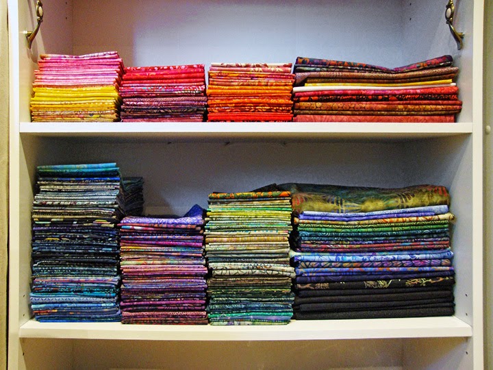 frabric storage system: larger and smaller folded pieces on the shelves frabric storage system: larger and smaller folded pieces on the shelves