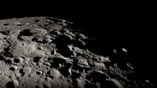 A close up of the moon's black and white, heavily cratered surface.