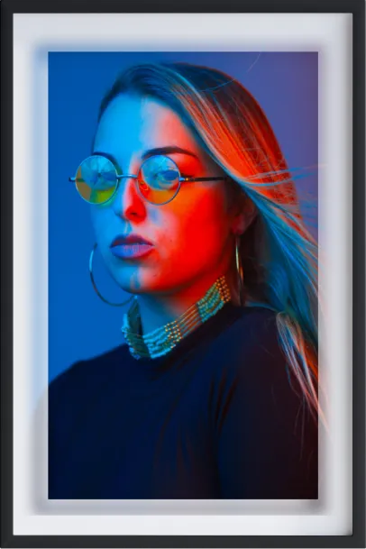 A portrait photo of woman with blue en red light on her face