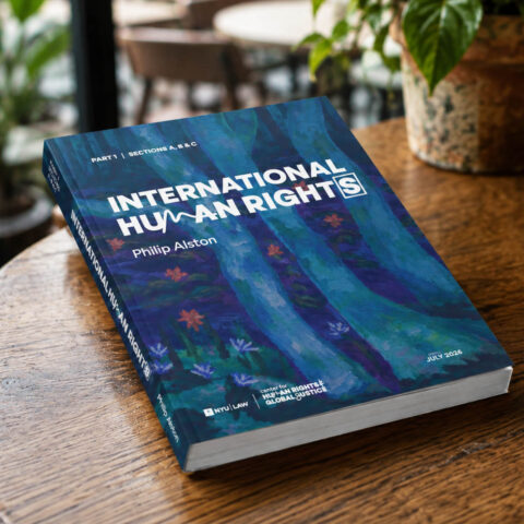 Print edition of Philip Alston's International Human Rights (2026) on a wooden table, published by the Center for Human Rights and Global Justice at NYU Law.