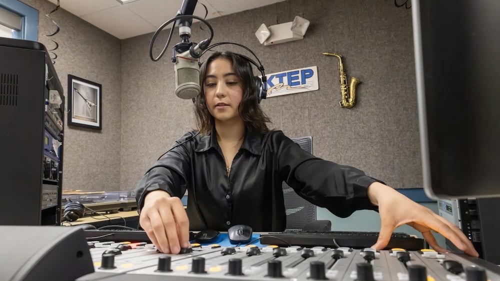 University of Texas at El Paso graduate student Eileen Espino sits in the KTEP studio and operates the soundboard.