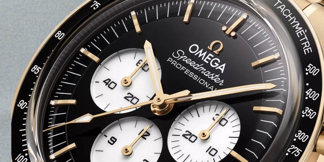 close up of omega speedmaster watch face with tachymeter scale and gold hands. close up of omega speedmaster watch face with tachymeter scale and gold hands.