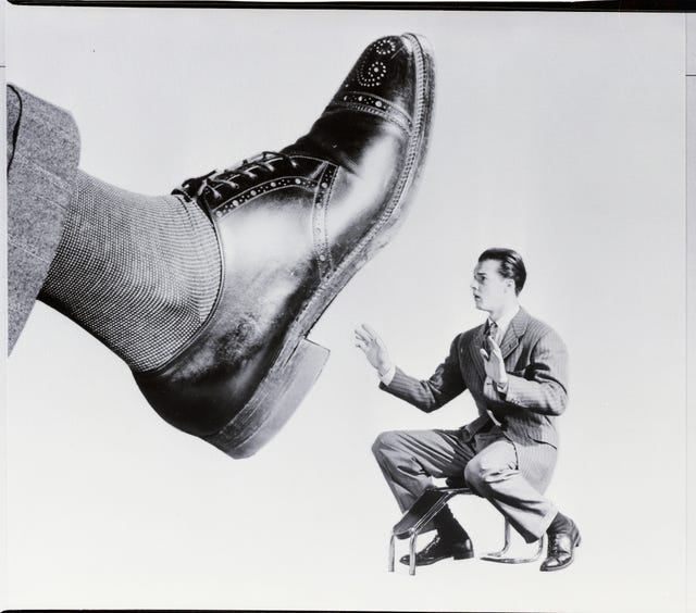 Shoe Salesman Faced with Giant Shoe Shoe Salesman Faced with Giant Shoe