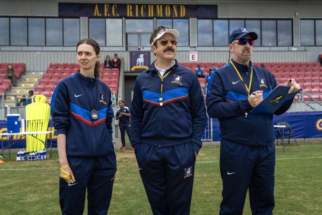 Three coaching staff members observing a soccer practice session at the A.F.C. Richmond field. Three coaching staff members observing a soccer practice session at the A.F.C. Richmond field.