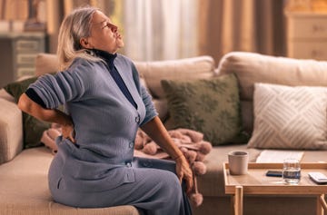 Elderly woman suffering from sudden back pain Elderly woman suffering from sudden back pain