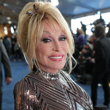 Dolly Parton at the 57th Academy of Country Music Awards in March 2022 dolly parton smiles at the camera in a patterned sequin dress with a butterfly clip in her hair while at the 57th academy of country music awards at allegiant stadium on march 07, 2022 in las vegas, nevada photo by kevin mazurgetty images for acm