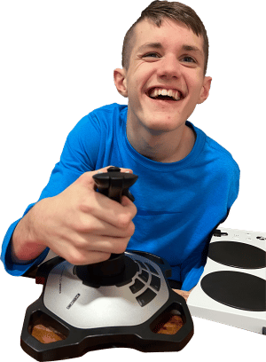 dylan 300 A young boy, 15 years old smiling using a joystick and an xbox adaptive controller in the background