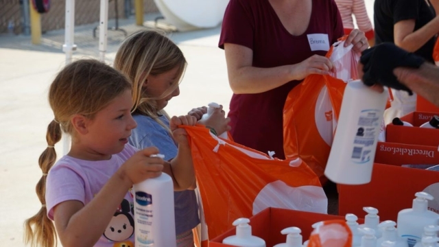 Volunteers packing Direct Relief emergency supplies into orange bags during the Louisiana floods.
