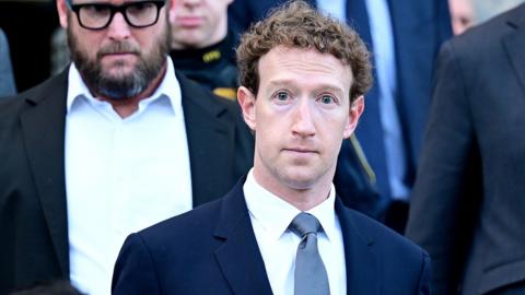Zuckerberg looks directly at the camera while wearing a blue suit and tie while descending the steps of the Superior Court in Los Angeles in February, surrounded by his legal team also wearing suits.