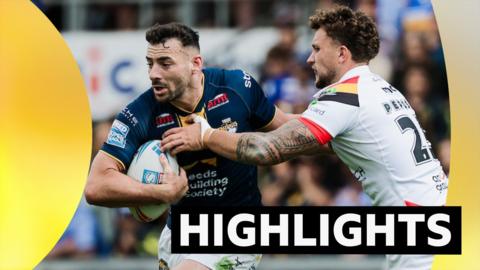 Jake Connor runs with the ball under his left arm as Eliot Peposhi grabs him to make a tackle