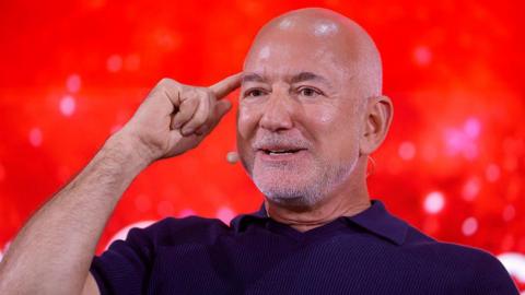 Jeff Bezos points to head