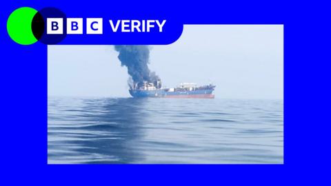 Smoke and flames plume from boat after it was hit