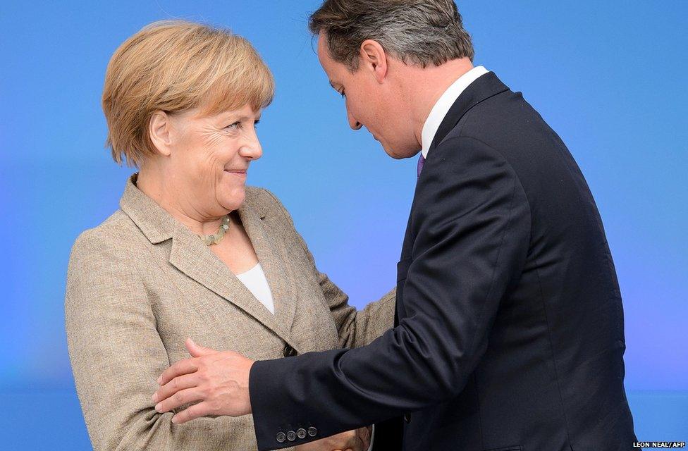 British Prime Minister David Cameron greets German Chancellor Angela Merkel during the 2014 Nato Summit in Newport, Wales
