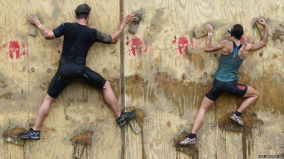 Competitors take part in the Spartan Sprint event at Pippingford Park in East Sussex.