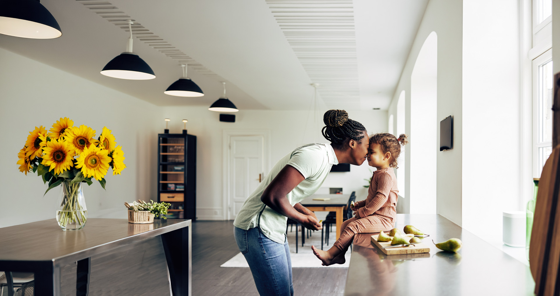 Mom and child in kitchen looking happy