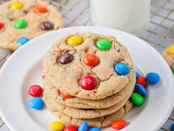 M&M cookie recipe stacked on top of each other on white plate.