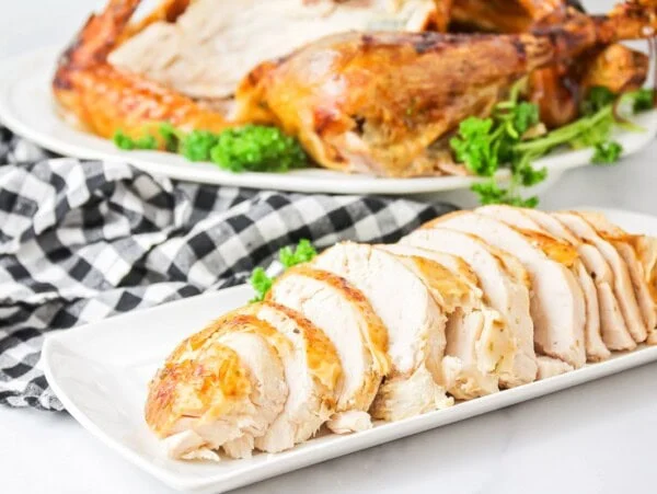 A sliced turkey seasoned in turkey brine.
