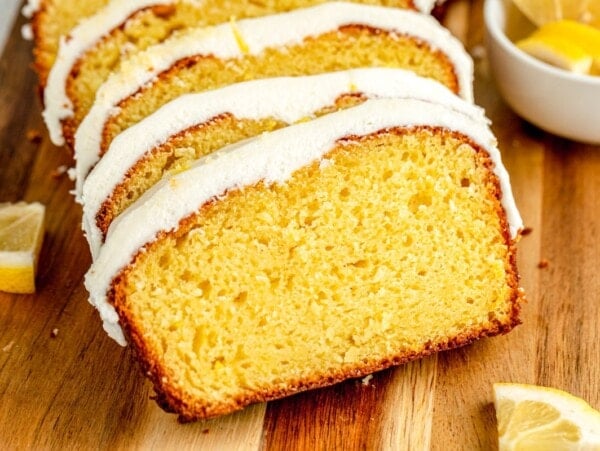 Frosted and sliced Starbucks lemon loaf recipe on a cutting board.
