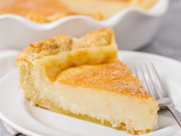 A slice of sugar cream pie recipe on a white plate.