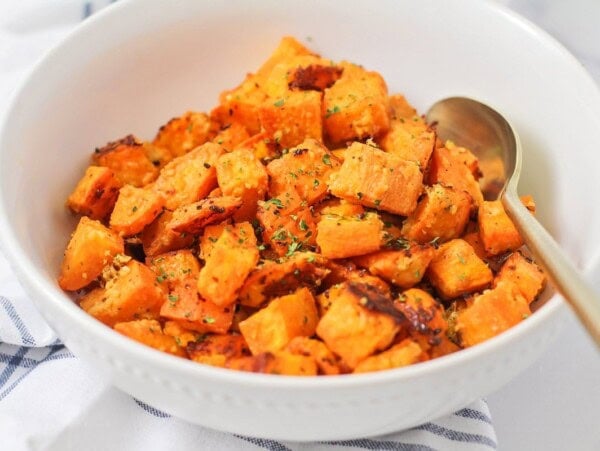 Roasted Sweet Potato Cubes served in a white bowl.