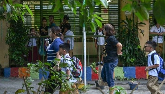 Parents accompany students as classes open for the new school year at an elementary school in Manila on June 16, 2025.
