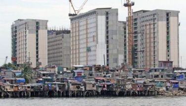 In this photo taken on July 9, 2026 shows Informal settlements stand in contrast to Manila's modern high-rise buildings.