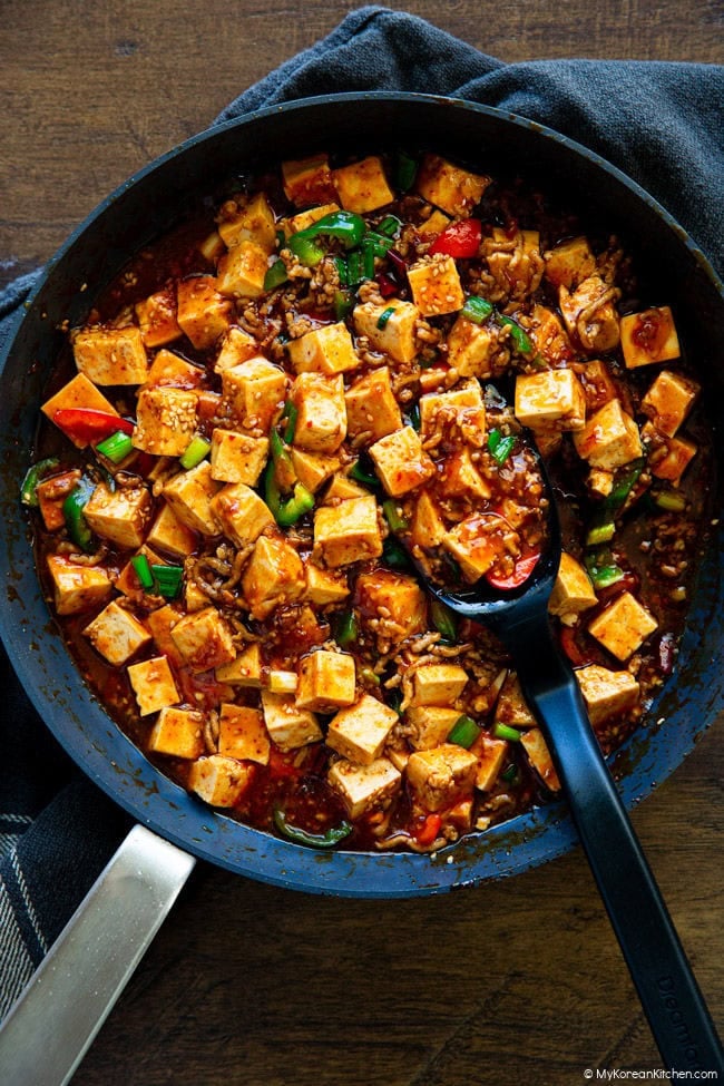 Korean mapo tofu served in a skillet with tender tofu cubes and rich spicy sauce