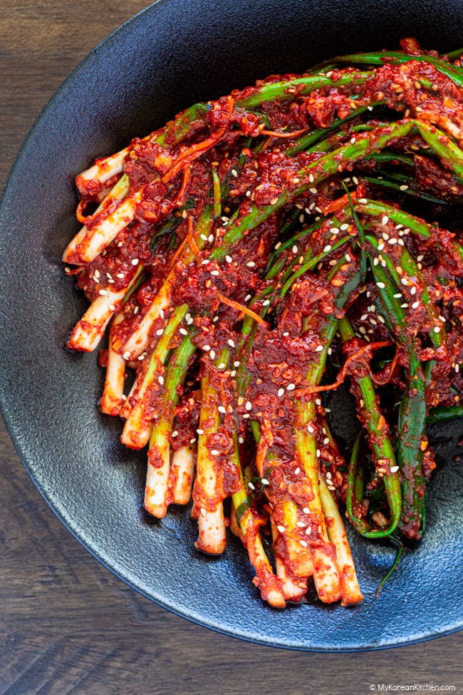pa kimchi served neatly on a shallow black bowl