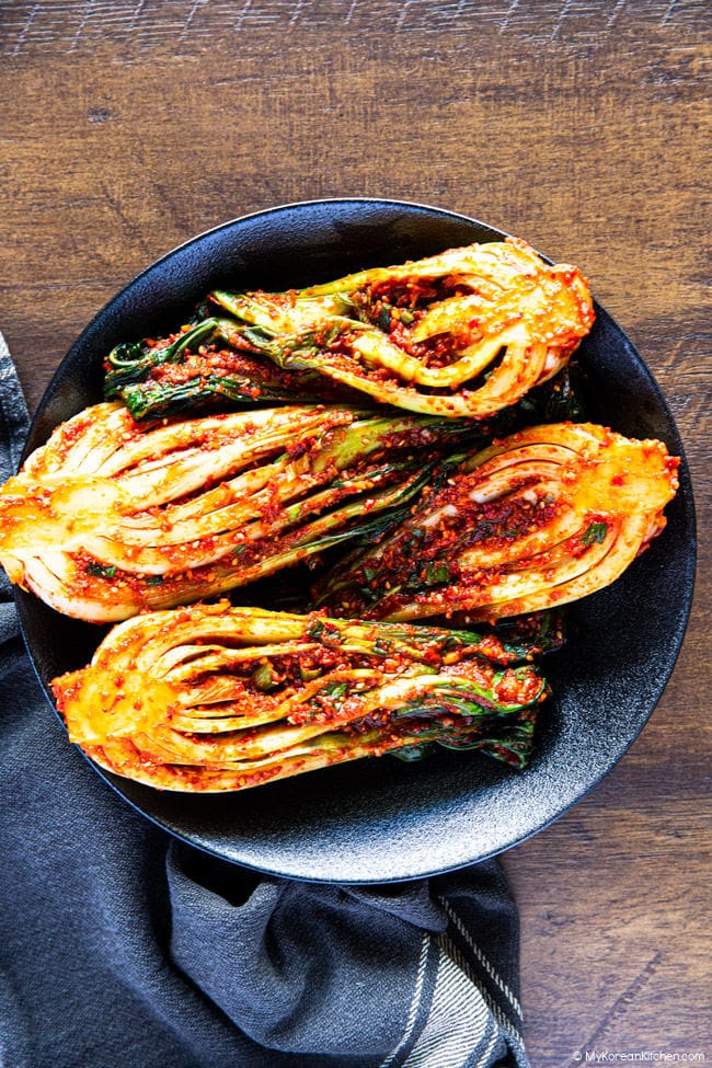 Homemade bok choy kimchi served in a black bowl