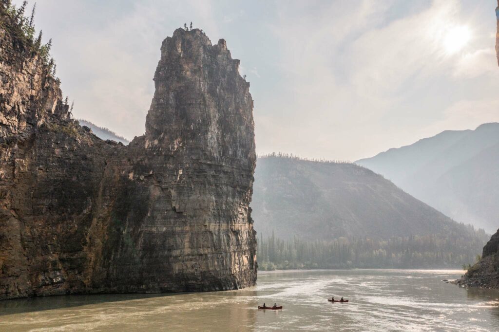 a group of people in canoes in a body of water