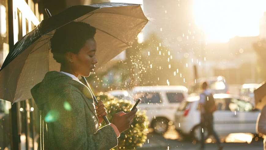 Business woman with umbrella in the rain