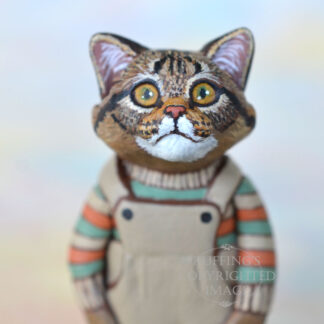 Maine Coon tabby-and-white kitten figurine in tan overalls and an orange, green, and tan striped shirt