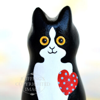 Black-and-white-tuxedo kitten with a red heart with blue polka dots
