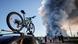 Bystanders watch as smoke rises from a fire at the Russian e-commerce firm Wildberries' logistics complexes in the town of Elektrostal outside Moscow. In the foreground is a car with a mountain bike strapped to the roof Bystanders watch as smoke rises from a fire at the Russian e-commerce firm Wildberries' logistics complexes in the town of Elektrostal outside Moscow. In the foreground is a car with a mountain bike strapped to the roof