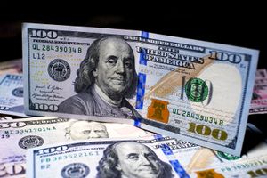 A $100 bill atop a pile of other bills