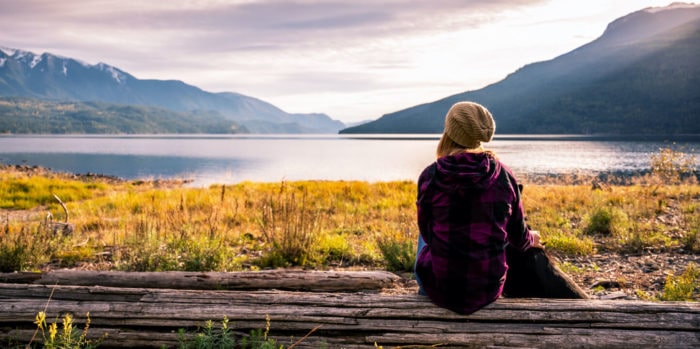 activities-nature-image@2x | Trans Canada Trail Woman looking at lake with mountains in the background