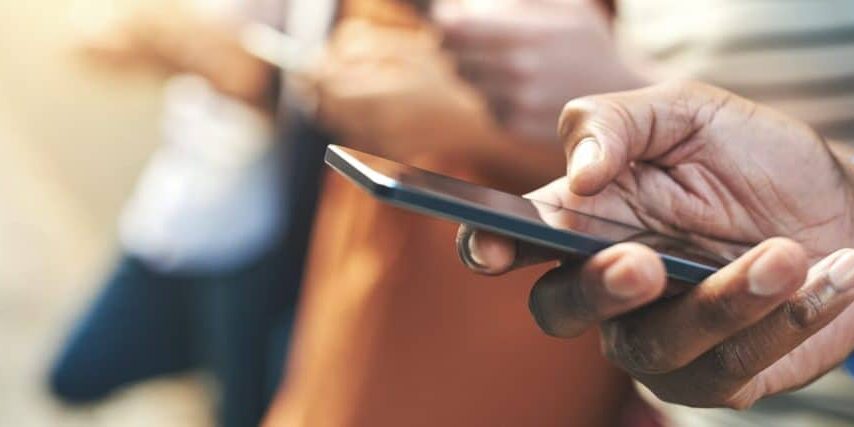 These days fingers do the talking Shot of an unrecognizable group of people social networking outside