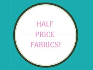 Half price fabrics sale sign